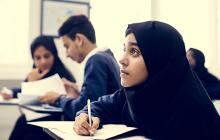 Student in hijab at school desk