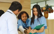 Healthcare trainee with coworkers