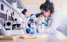 Female scientist at microscope
