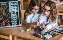 Two young girls working on a STEM project