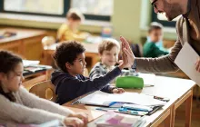 Teacher and student high-fiving
