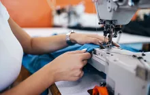 Woman's hands working at a sewing machine