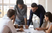 Coworkers working together over a table