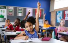 Elementary student raising her hand
