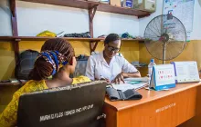 African woman at desk in health center