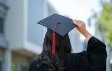 Back of graduate holding her mortarboard