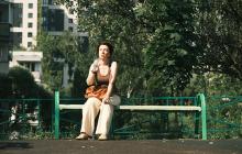 Woman in heat wave on a bench