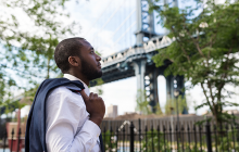 Man looking pensive near Brooklyn Bridge