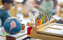 Social studies classroom showing a globe and colored pencils