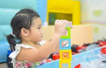 preschool girl stacking blocks