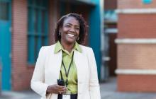 Principal outside a school holding a radio