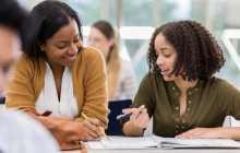 two teachers talking at a table