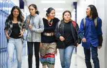 Native American students walking in school hallway