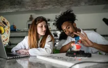 college biology students examining eye model