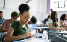 Young woman studying at classroom desk