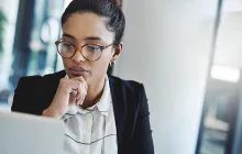 female employee looking thoughtfully at computer