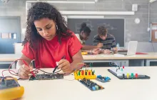 female high school student working on robotics project