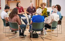 People Attending Self Help Therapy Group Meeting In Community Center