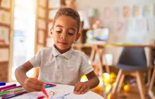 boy coloring in preschool