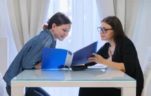 Teacher and student looking at folder