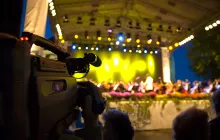 Videographer filming arts performance