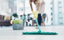 Domestic worker mopping the floor in nice apartment