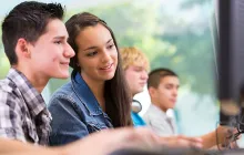 High school students working together at a desktop