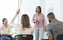 Image of teacher in classroom addressing other teachers in a training