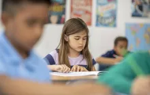Elementary student reading in class