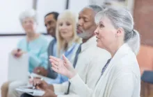 Woman answering question in group.