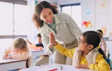 Teacher high fiving student