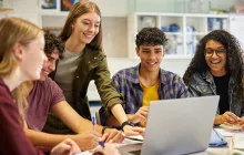 High school students working at a laptop