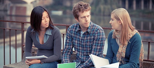 Image of young adults talking on campus