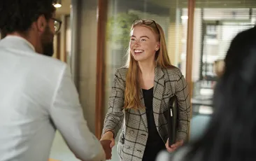 Woman shaking hand with colleague
