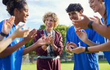 Coach celebrating outside with players